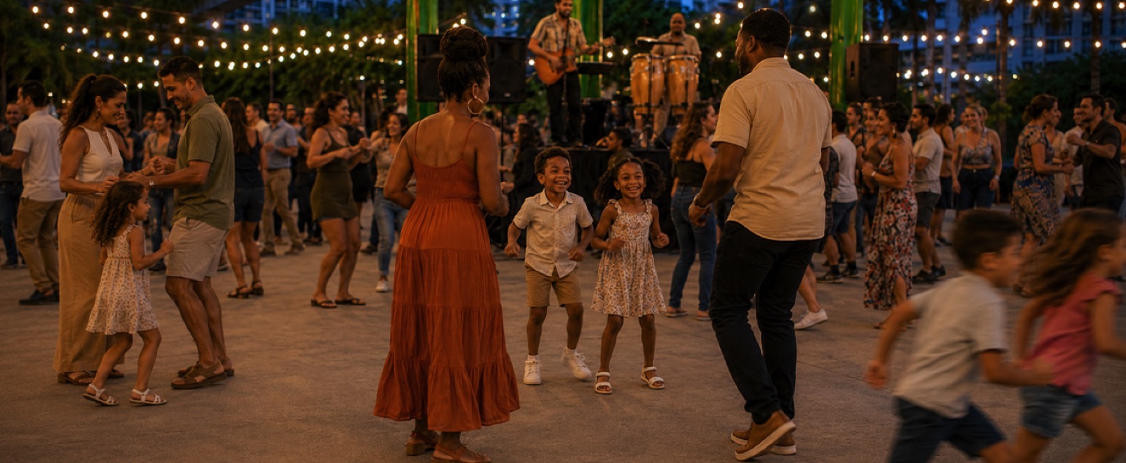 Families dancing outdoors at night